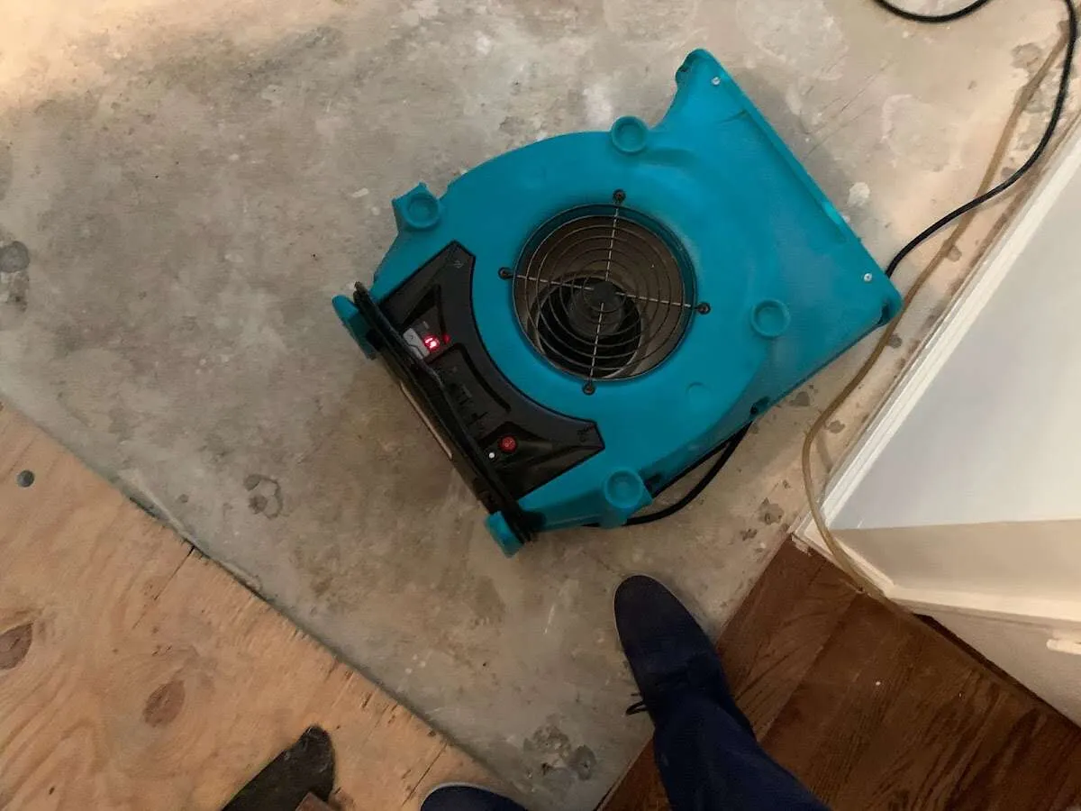 Air mover drying subfloor during Commercial Water Damage Restoration in Little River